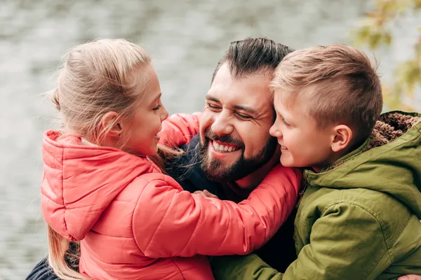 dad hugging 2 sons