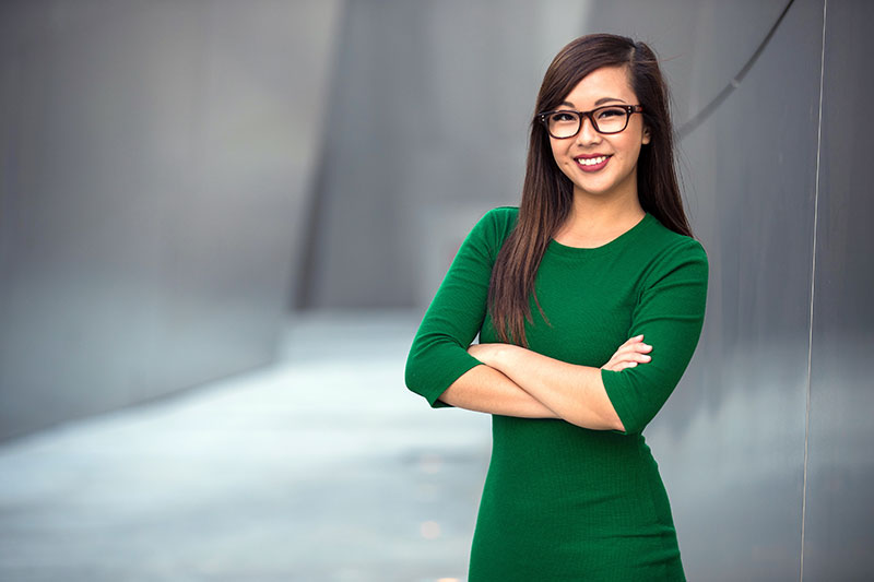Portrait of a young professional business woman staff leader confident with arms folded